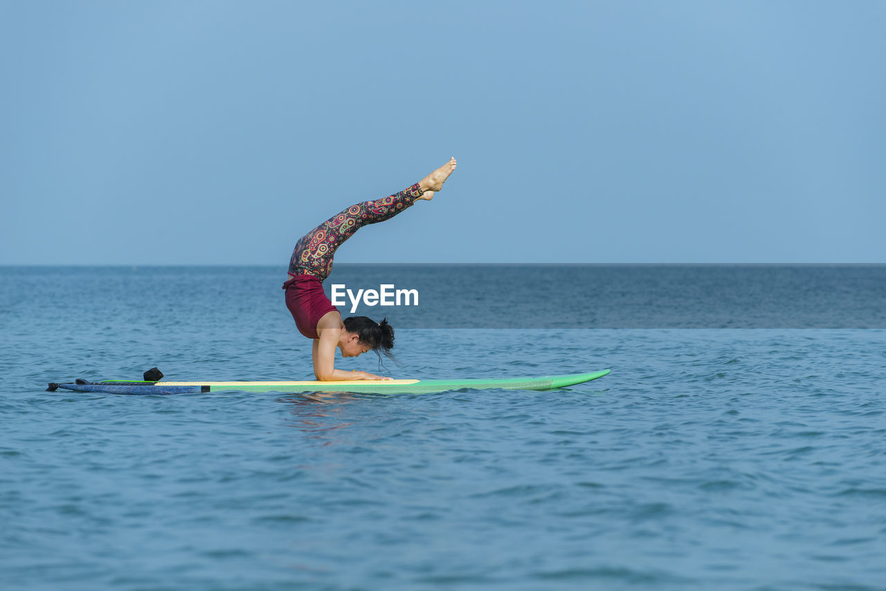 Yogini. yoga on paddle board
