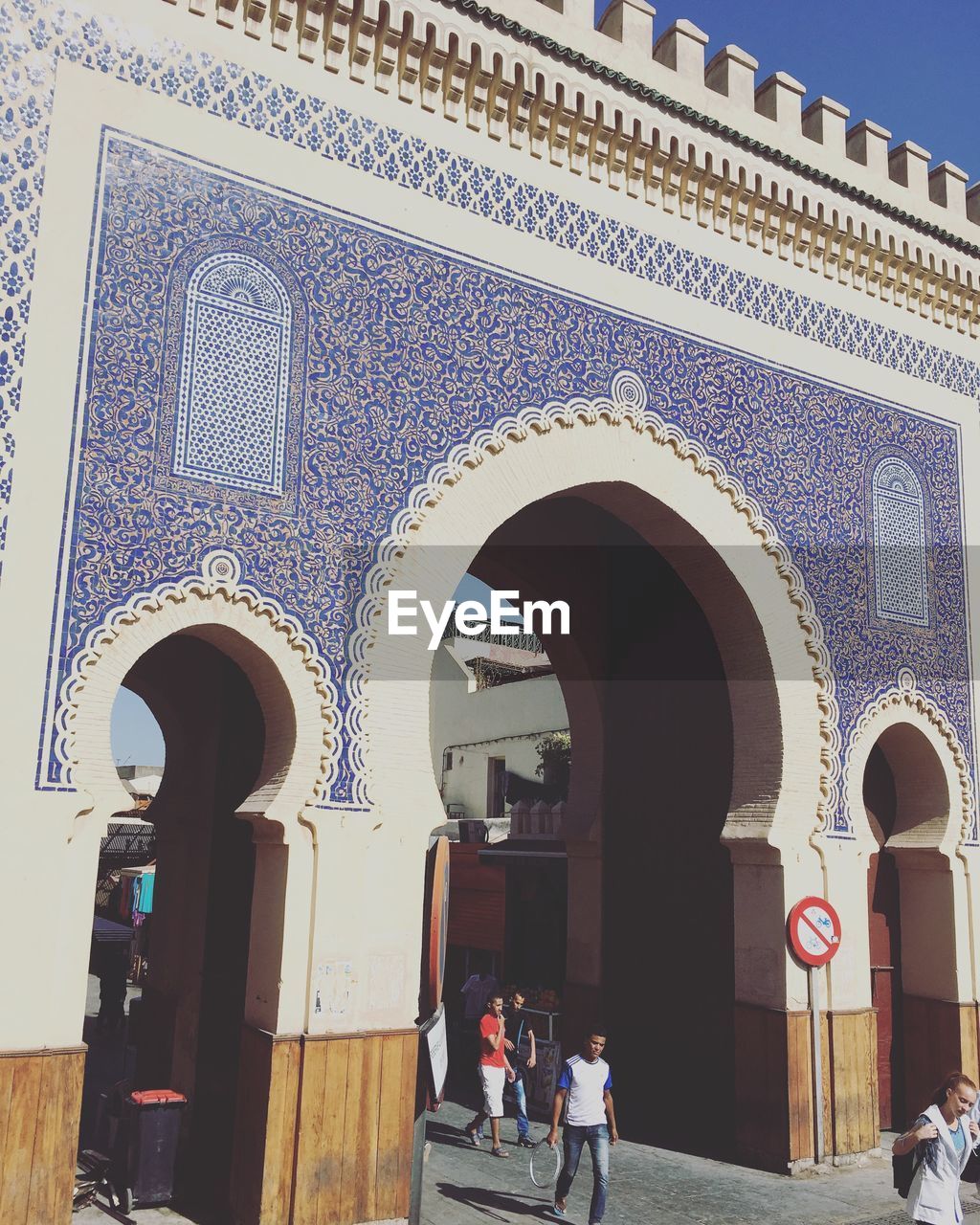 LOW ANGLE VIEW OF ORNATE ENTRANCE OF HISTORIC TEMPLE