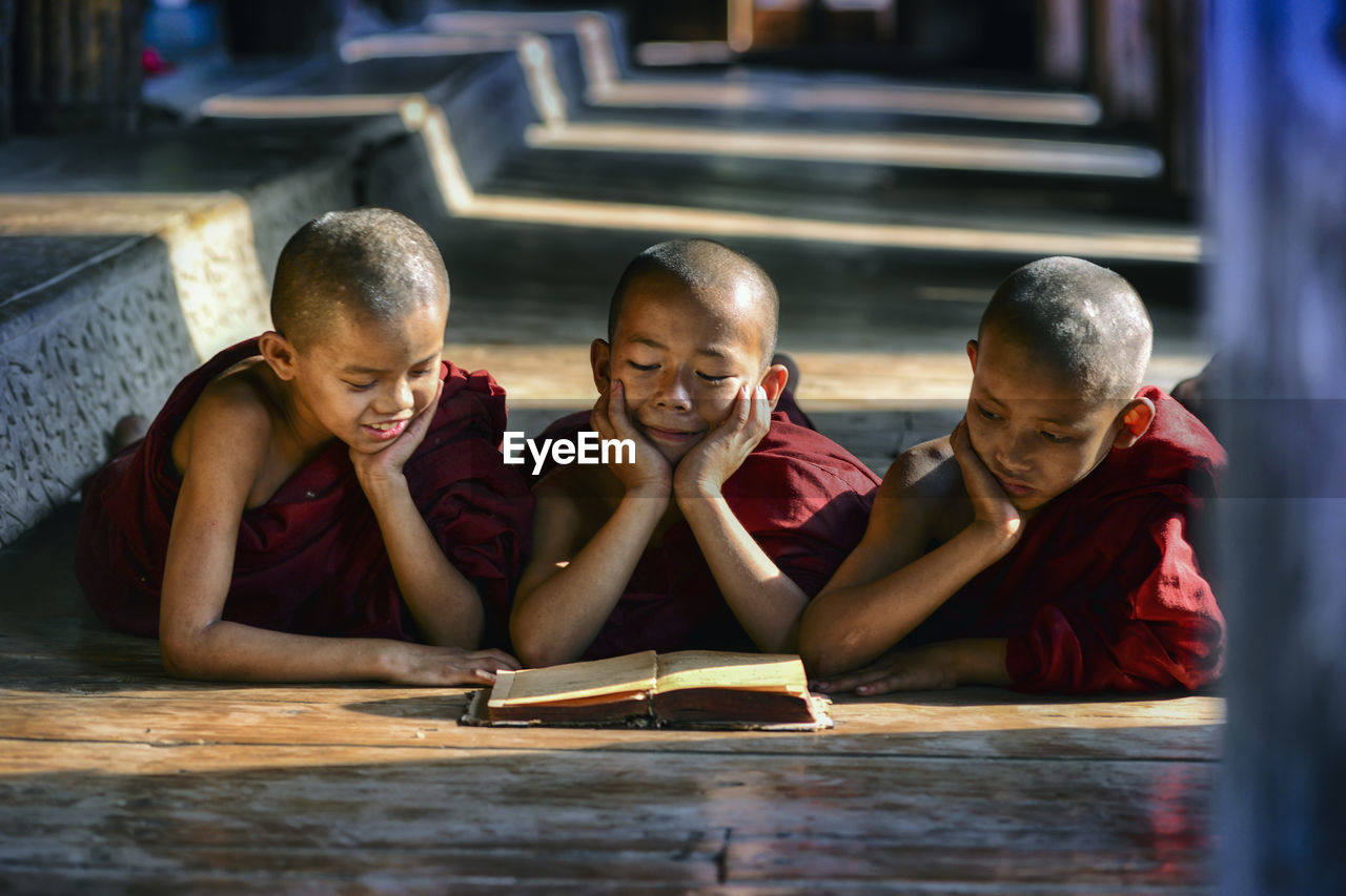 Monks reading book at temple