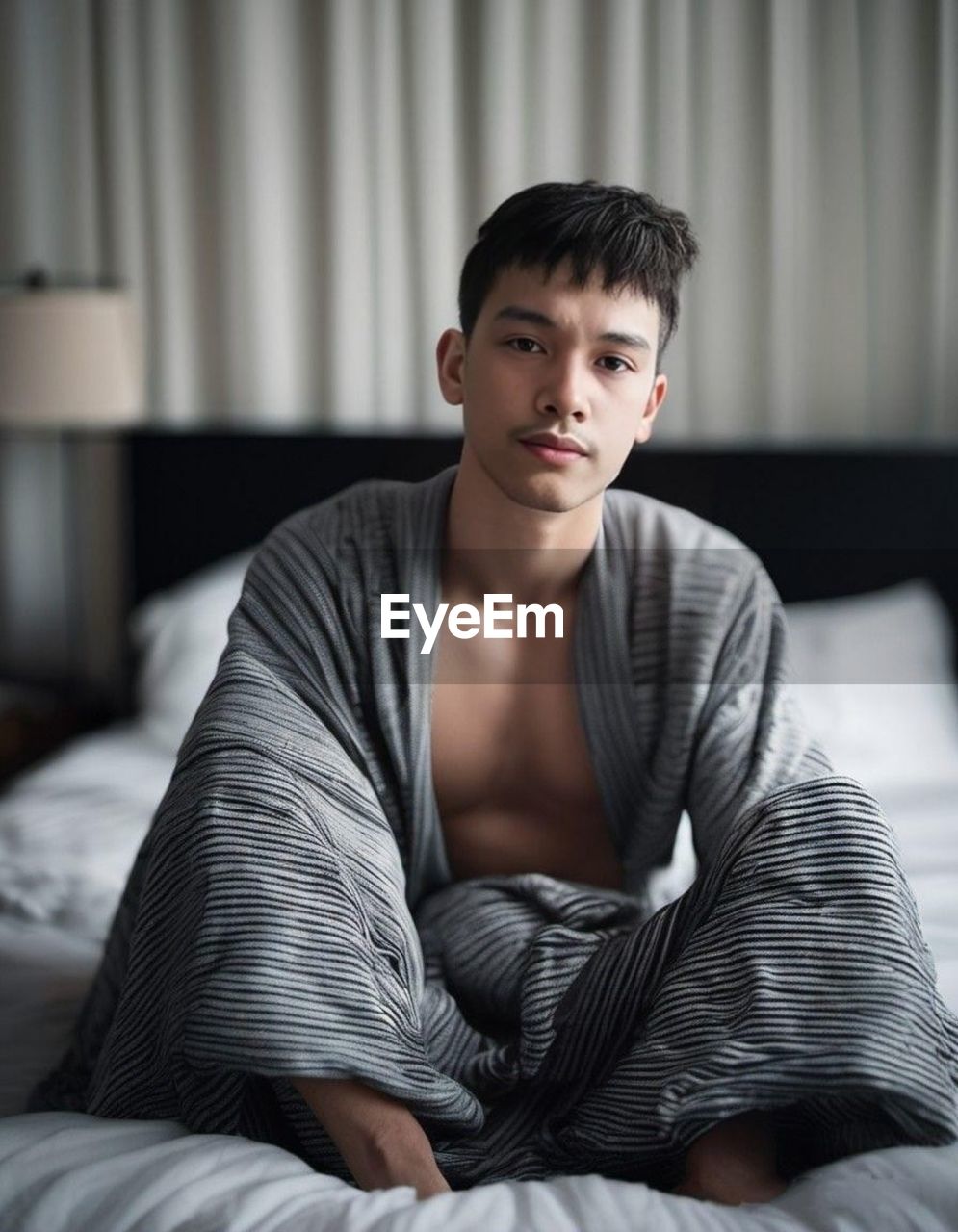 portrait of boy sitting on sofa at home
