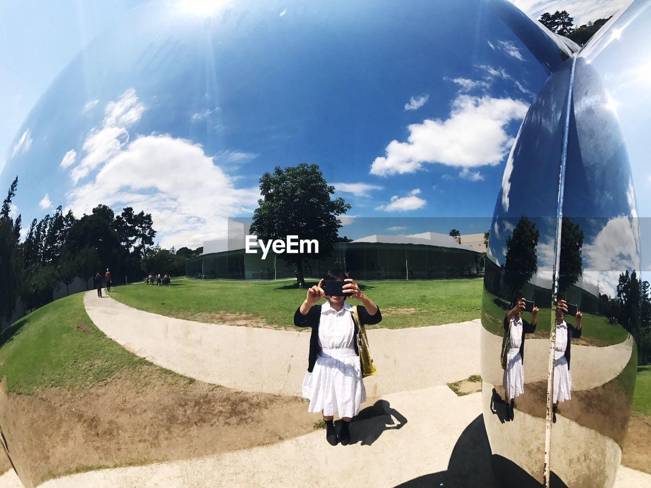 PANORAMIC VIEW OF PEOPLE IN PARK AGAINST SKY