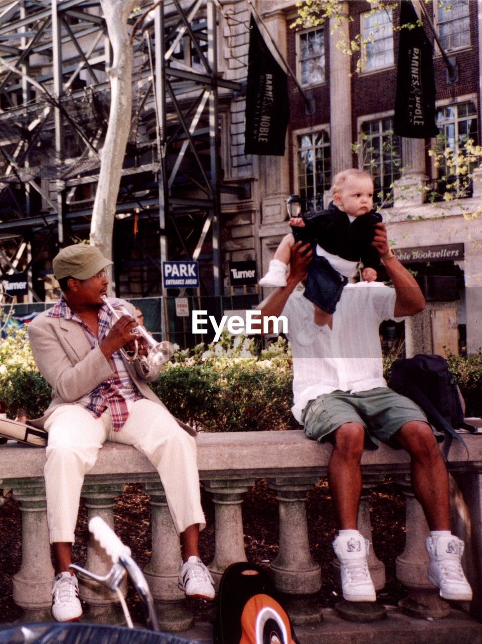 FULL LENGTH PORTRAIT OF MEN SITTING IN PARK