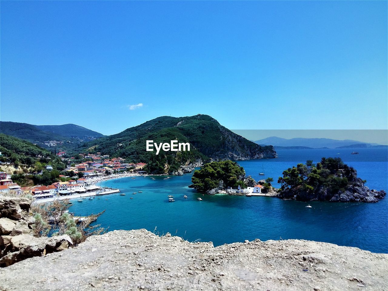 Scenic view of bay against clear blue sky