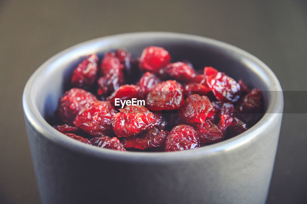 CLOSE-UP OF STRAWBERRIES IN BOWL AT TABLE