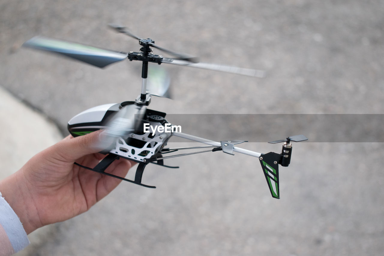 Child playing with radio-controlled helicopter.