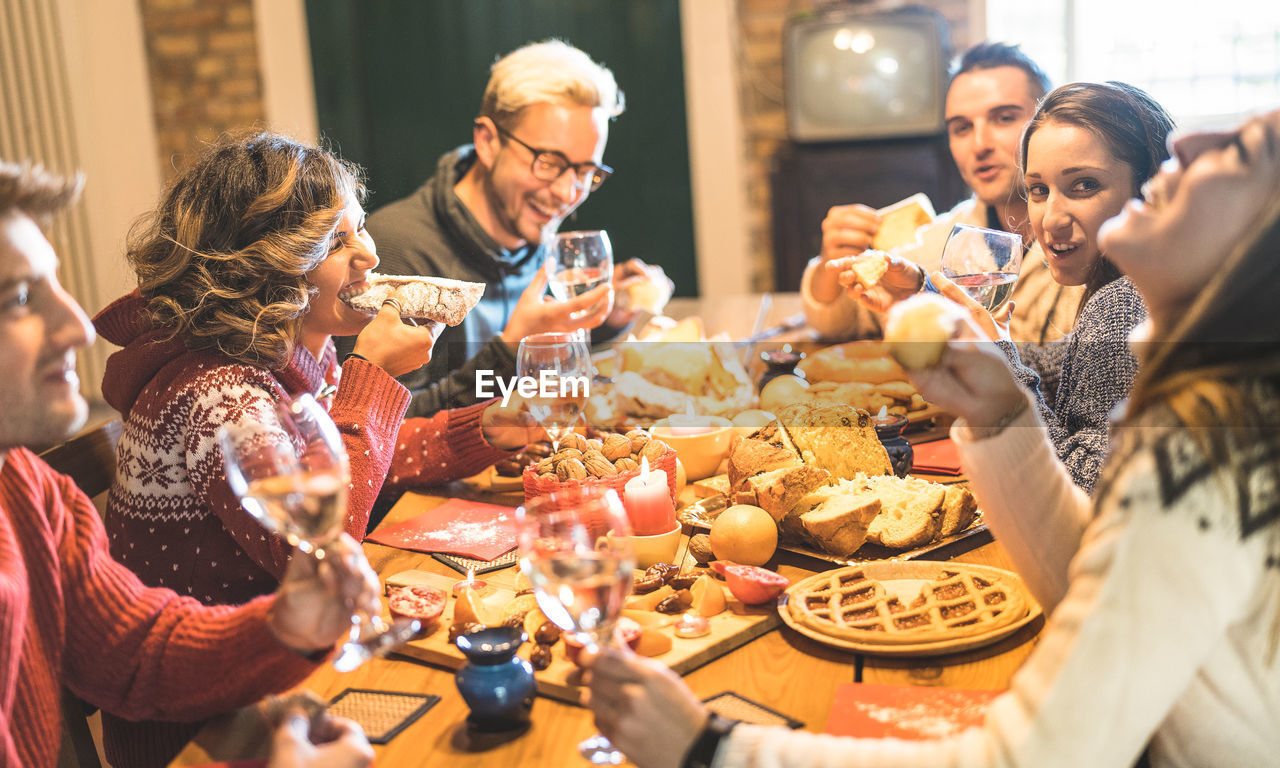 People enjoying food and drink on table