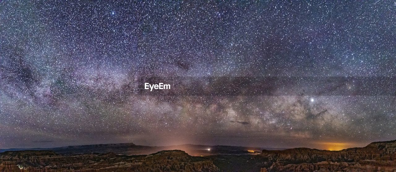 Scenic view of landscape against star field