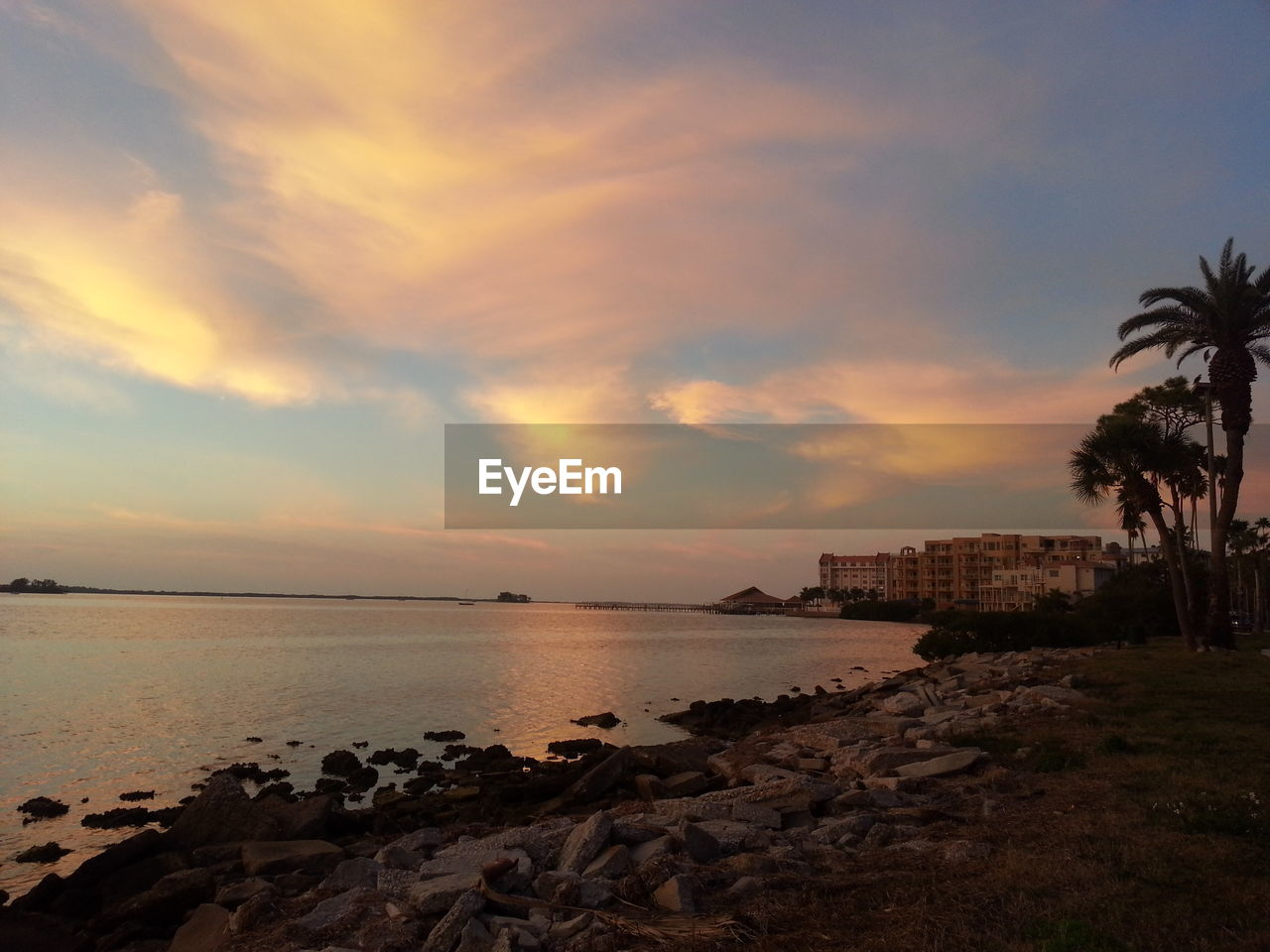 Scenic view of sea at sunset against sky