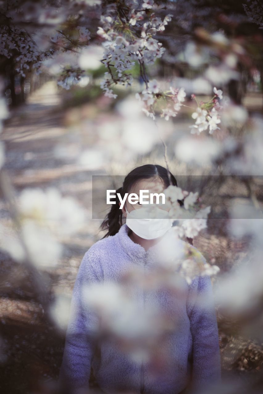 High angle view of girl wearing mask standing in park