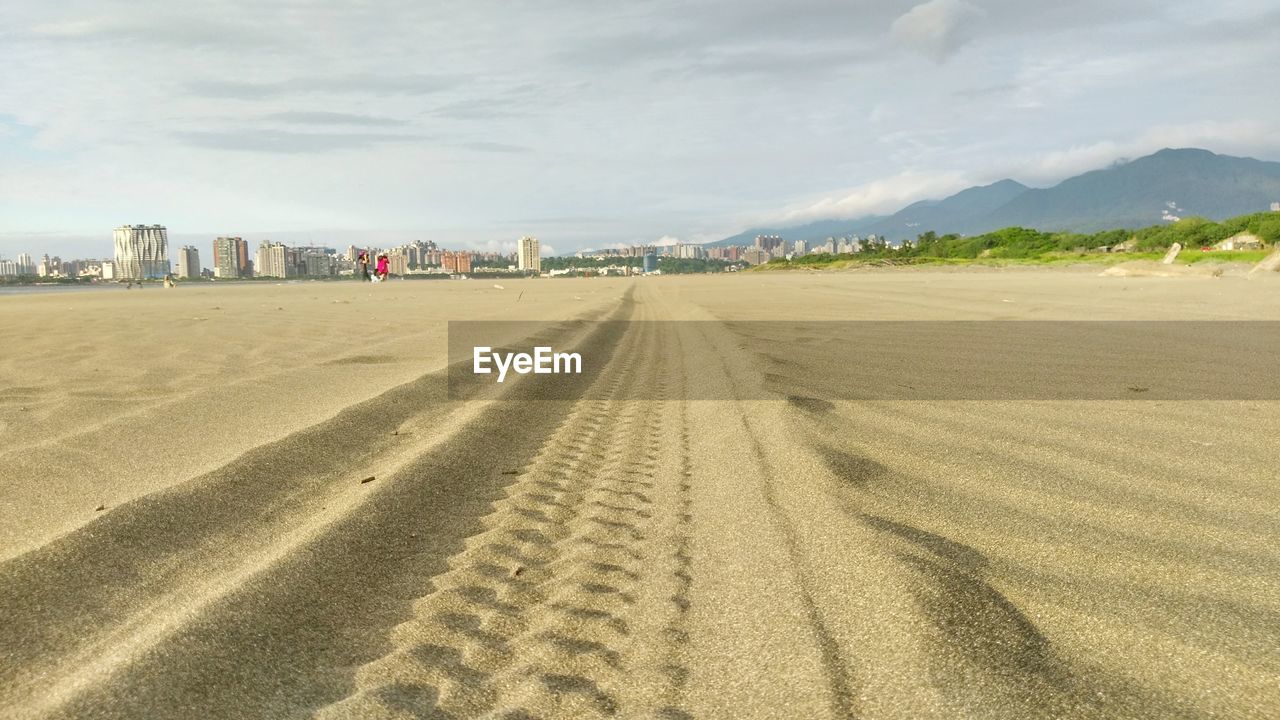 TIRE TRACKS ON BEACH