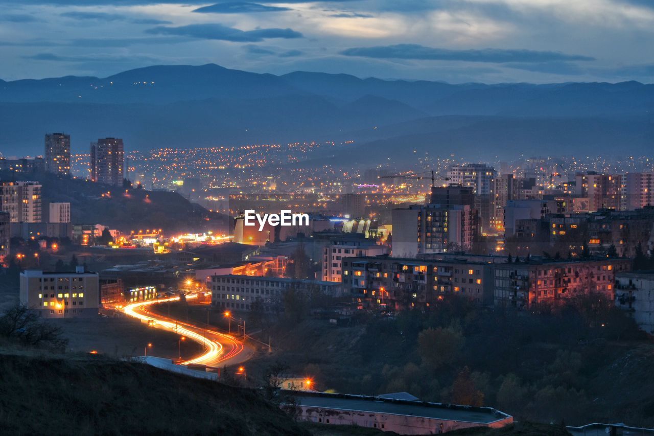 High angle view of illuminated buildings in city at dusk