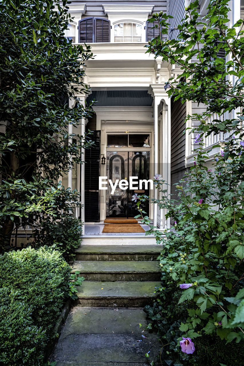 architecture, built structure, plant, building exterior, garden, home, building, courtyard, house, residential district, entrance, estate, yard, nature, no people, flower, backyard, growth, mansion, door, tree, day, outdoors, staircase, lawn, facade, front or back yard, architectural column, window, flowering plant, green, bush, formal garden, neighbourhood