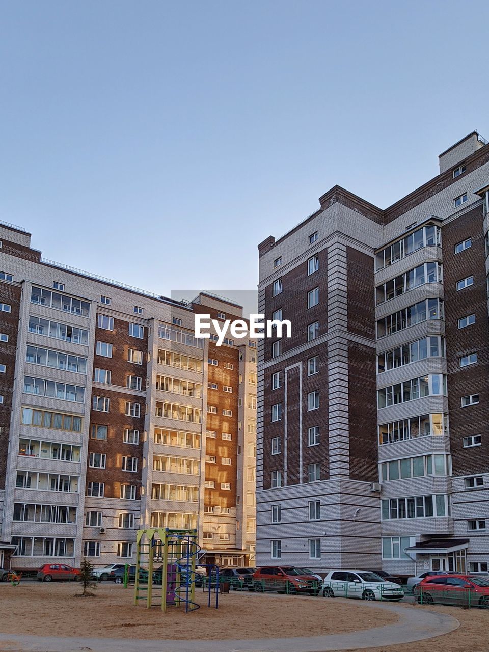 Low angle view of buildings against clear blue sky