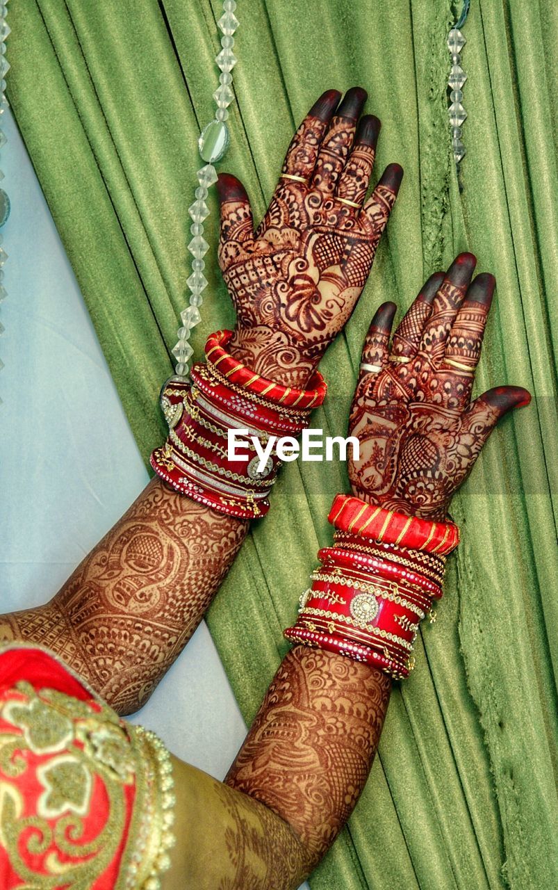 Cropped image of bride showing henna tattoo