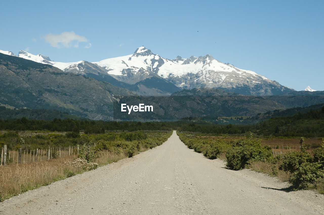 Road amidst mountains against sky