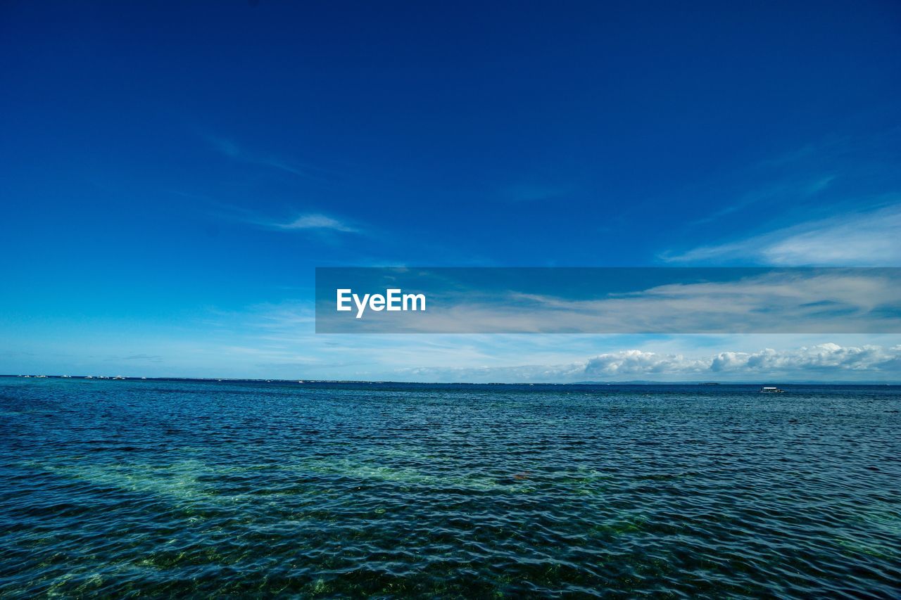 Scenic view of sea against blue sky