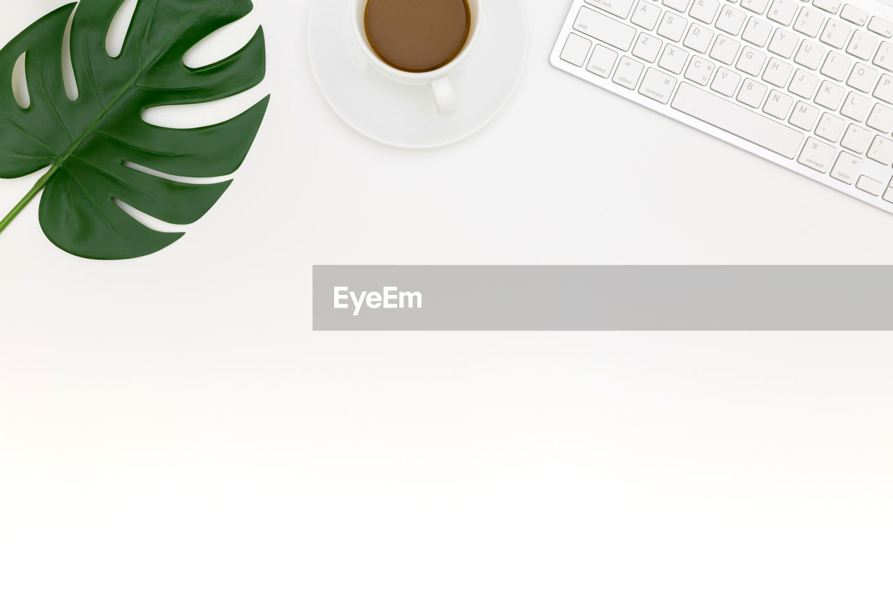 HIGH ANGLE VIEW OF COFFEE CUP ON TABLE AT HOME