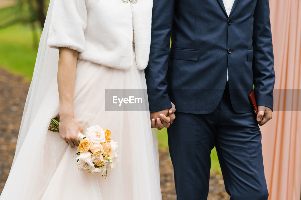 The bride and groom are holding hands. st. valentine's day in a couple person