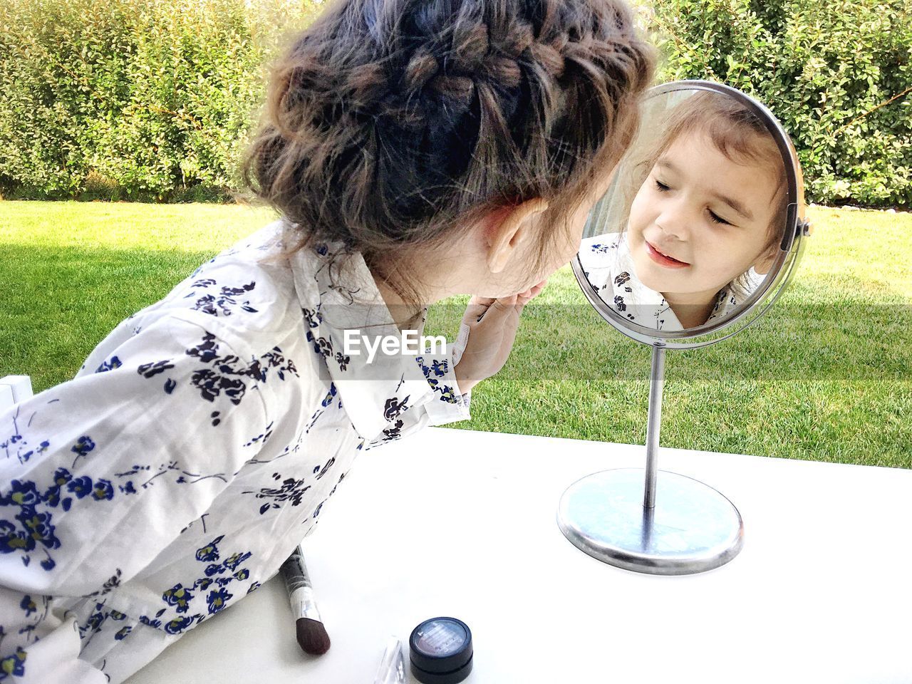 Close-up of girl looking in mirror