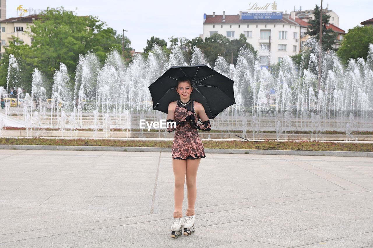 FULL LENGTH OF WOMAN WITH FOUNTAIN