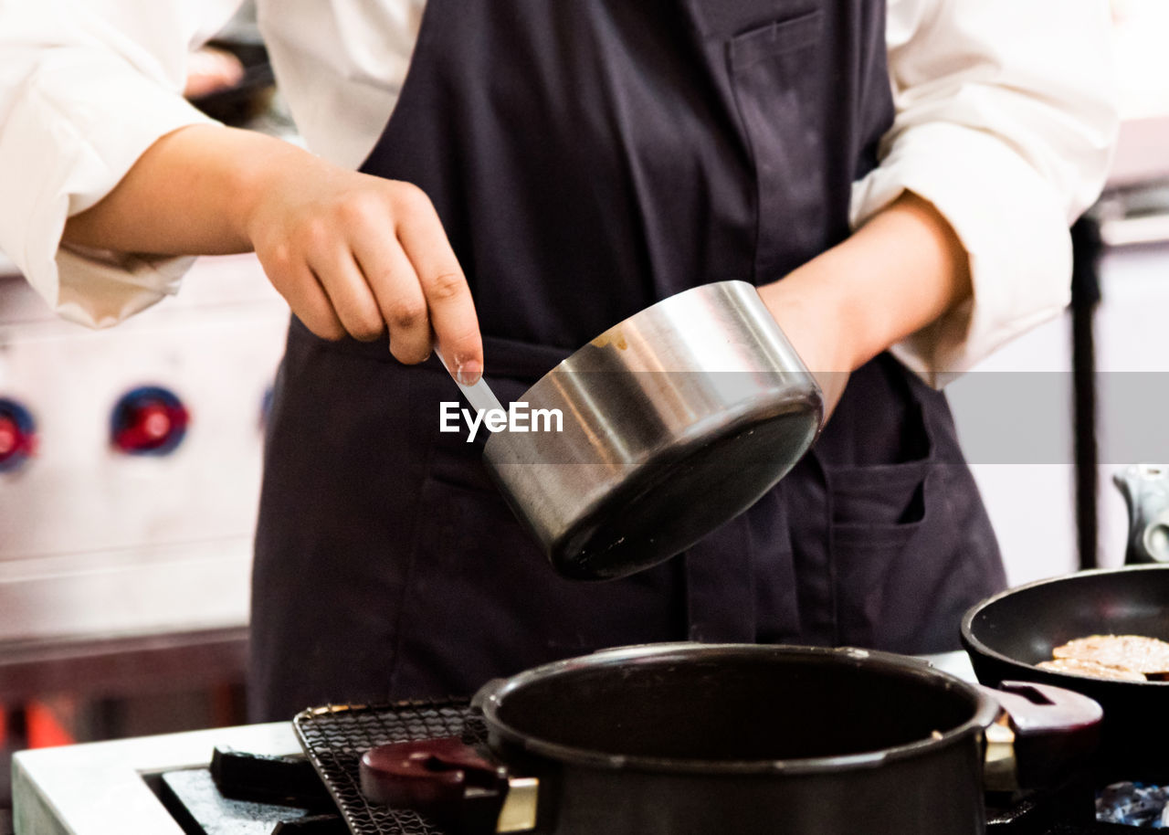 midsection of woman preparing food