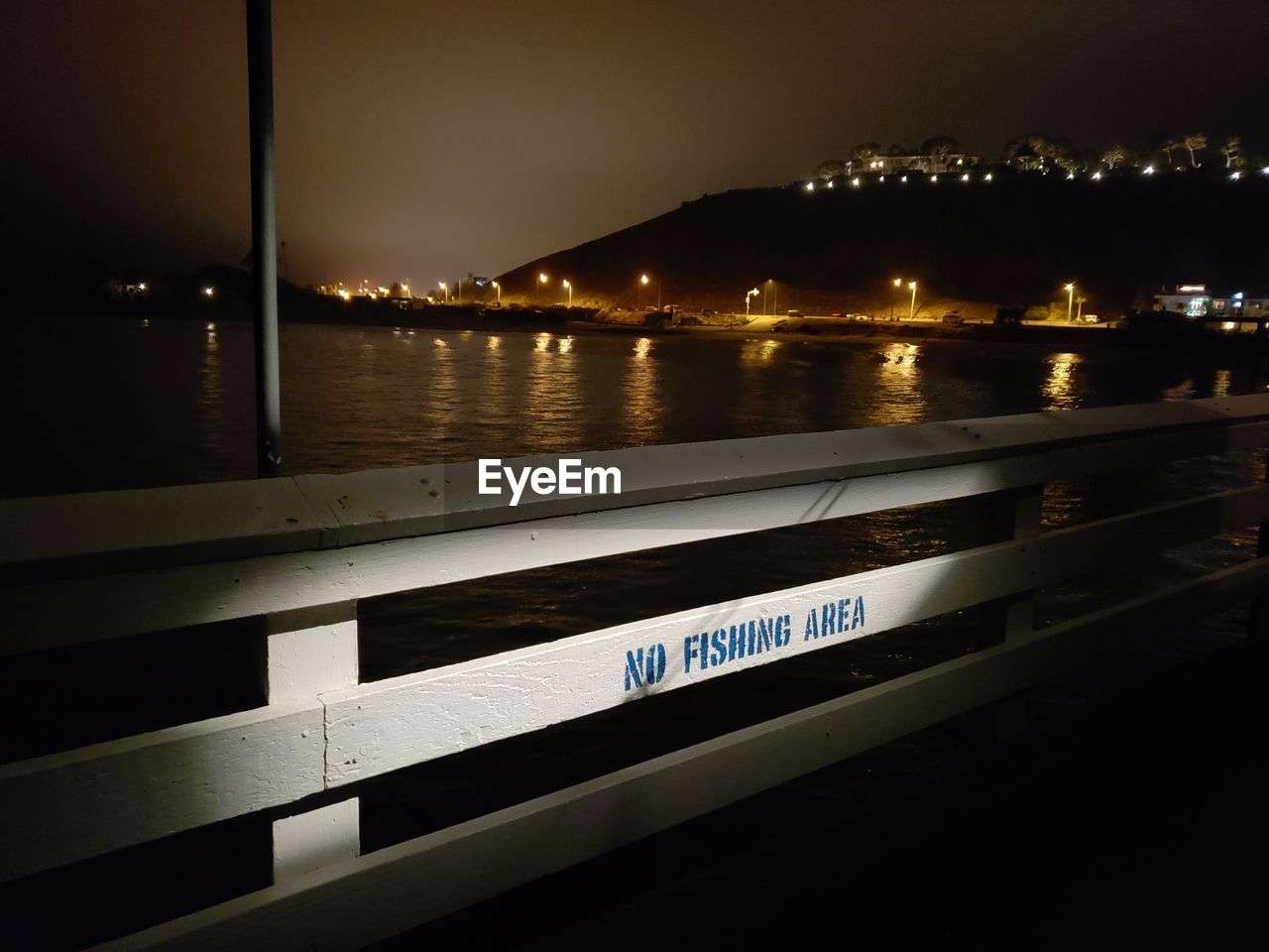 ILLUMINATED TEXT BY RIVER AT NIGHT