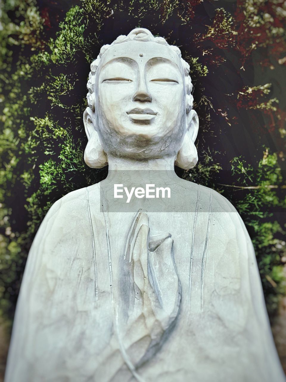 White buddha statue in garden