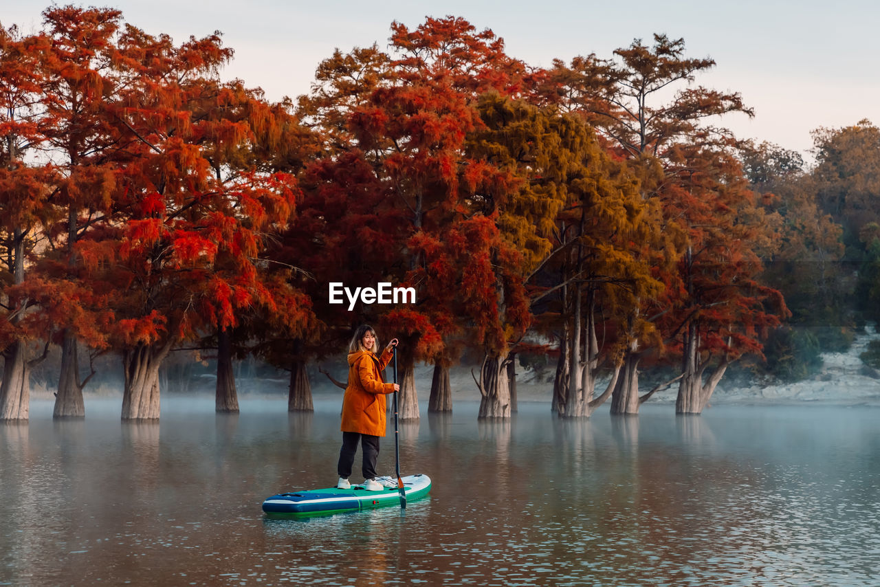 rear view of woman walking on lake