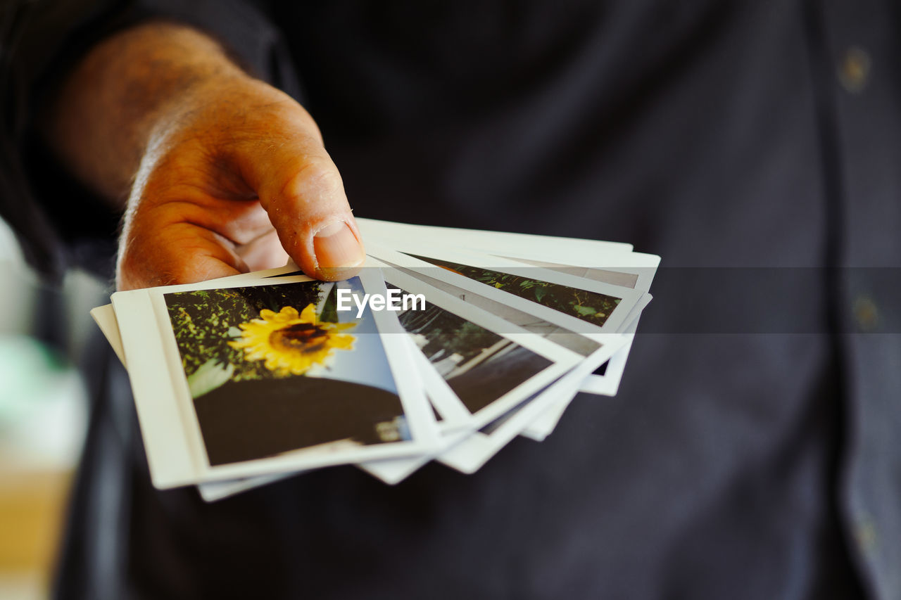 Midsection of man holding instant print transfers