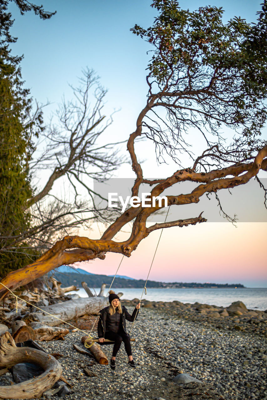 MAN ON SHORE AGAINST SKY
