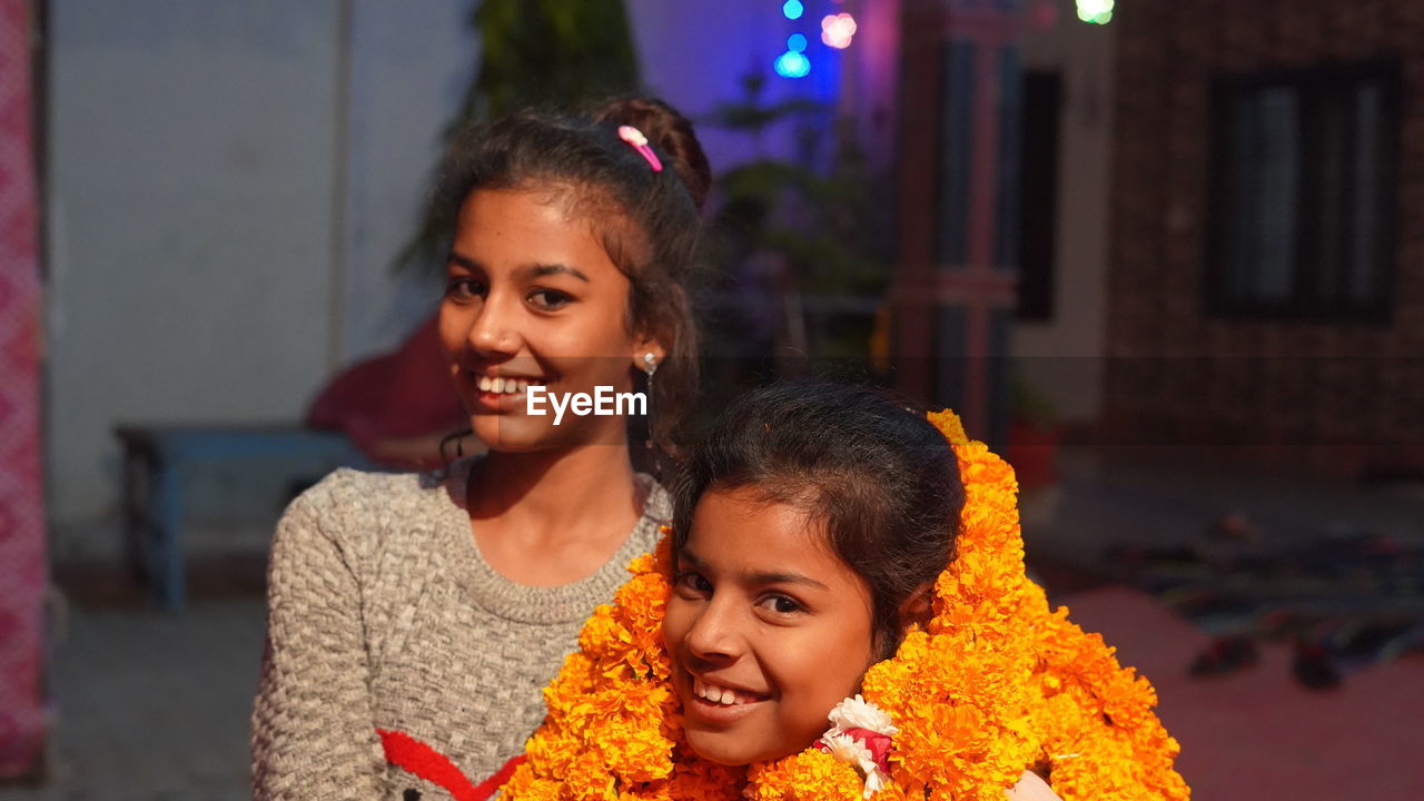 Two rajasthani girl pose a picture at birthday party. close up shot of happy asian girls.