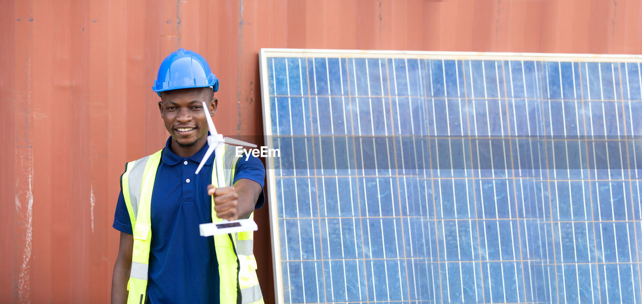 MAN WORKING WITH ARMS RAISED