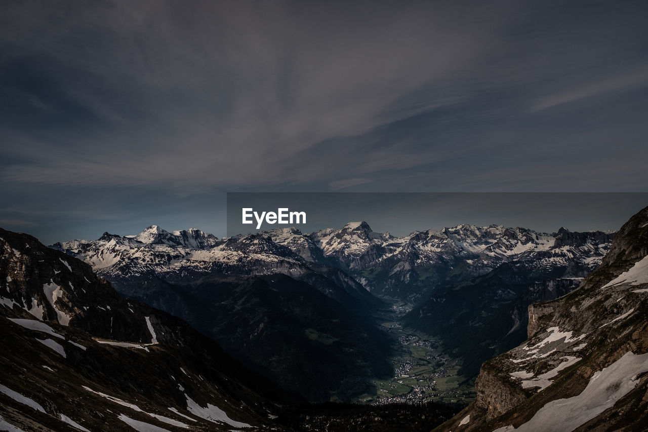 Scenic view of snowcapped mountains against sky during winter