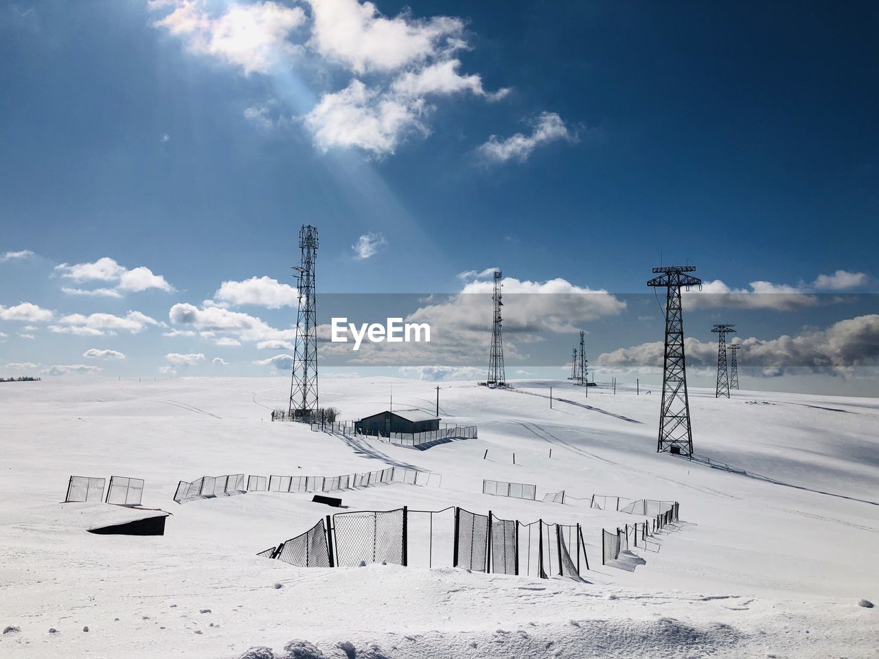 Scenic view of snow covered field against sky