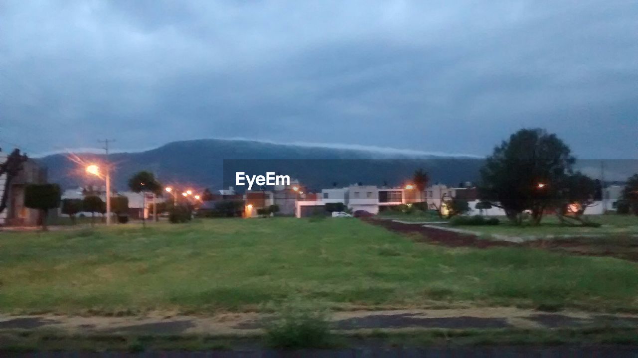 VIEW OF LANDSCAPE AGAINST CLOUDY SKY AT NIGHT