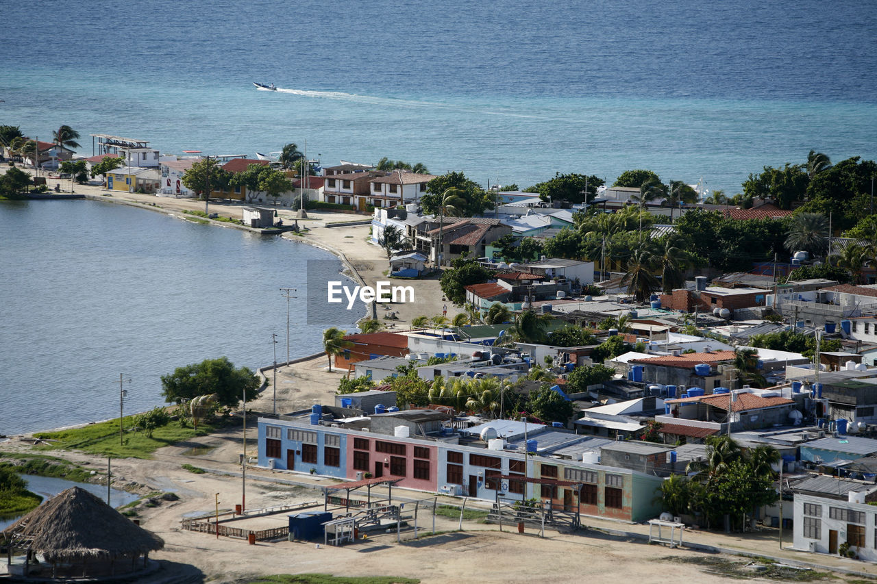 High angle view of cityscape by sea