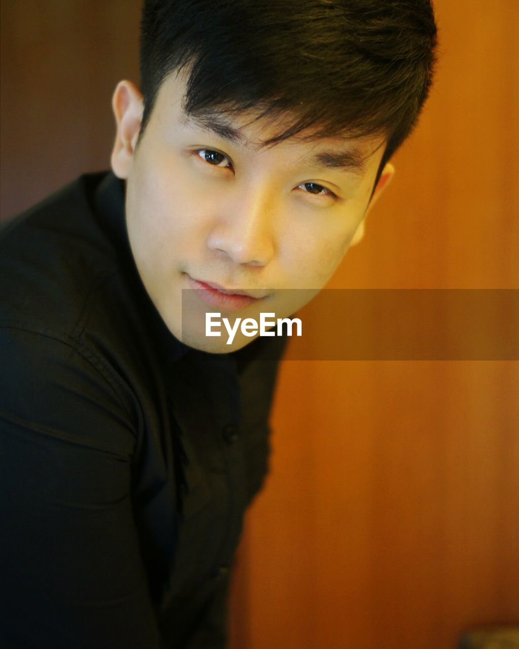 Close-up portrait of handsome man standing at home