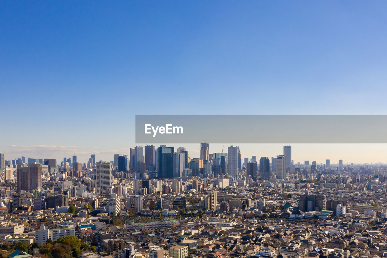 AERIAL VIEW OF MODERN BUILDINGS AGAINST SKY IN CITY