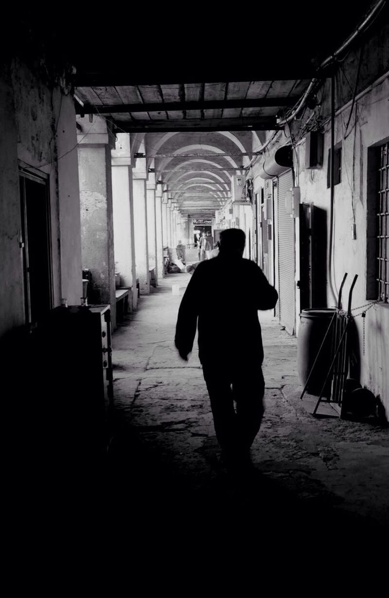 FULL LENGTH REAR VIEW OF WOMAN WALKING IN TUNNEL