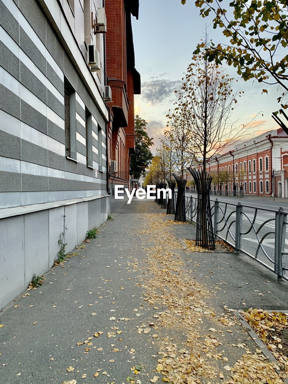 EMPTY FOOTPATH AMIDST BUILDINGS