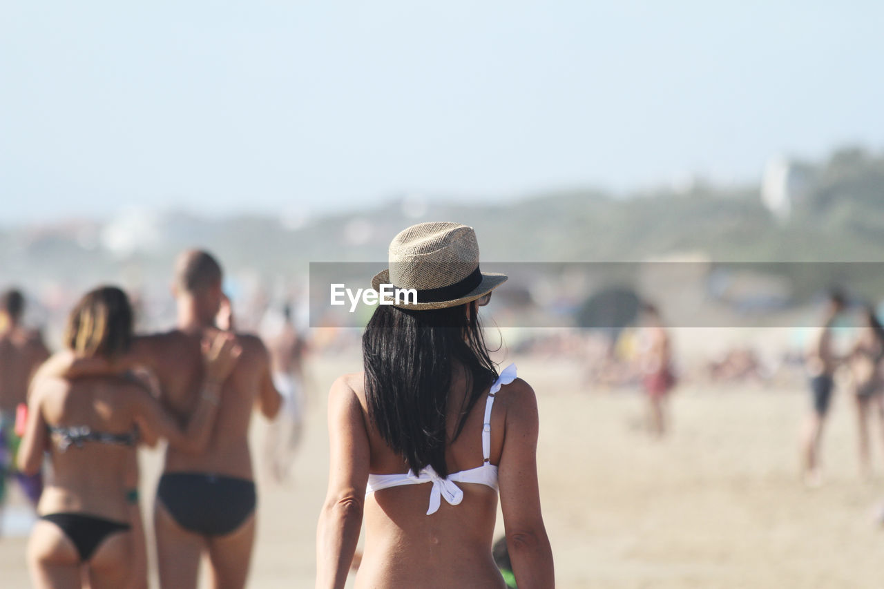 Rear view of woman wearing hat at beach 