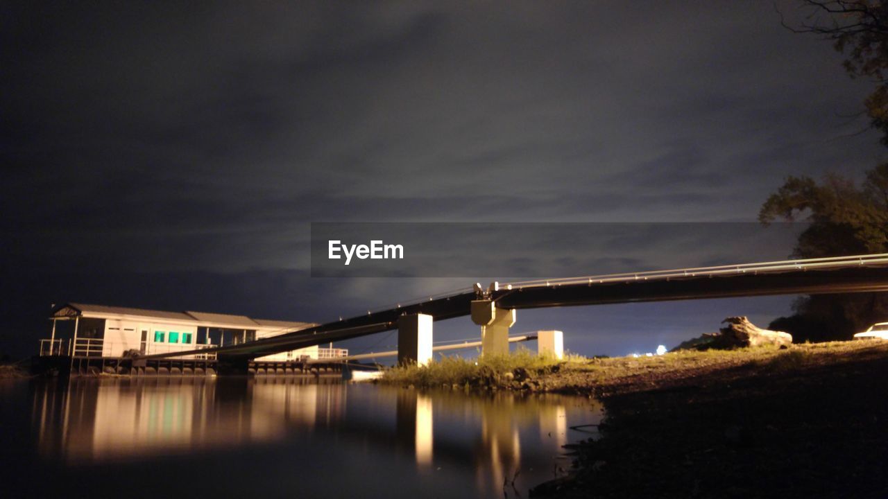 BRIDGE OVER RIVER WITH BUILDINGS IN BACKGROUND