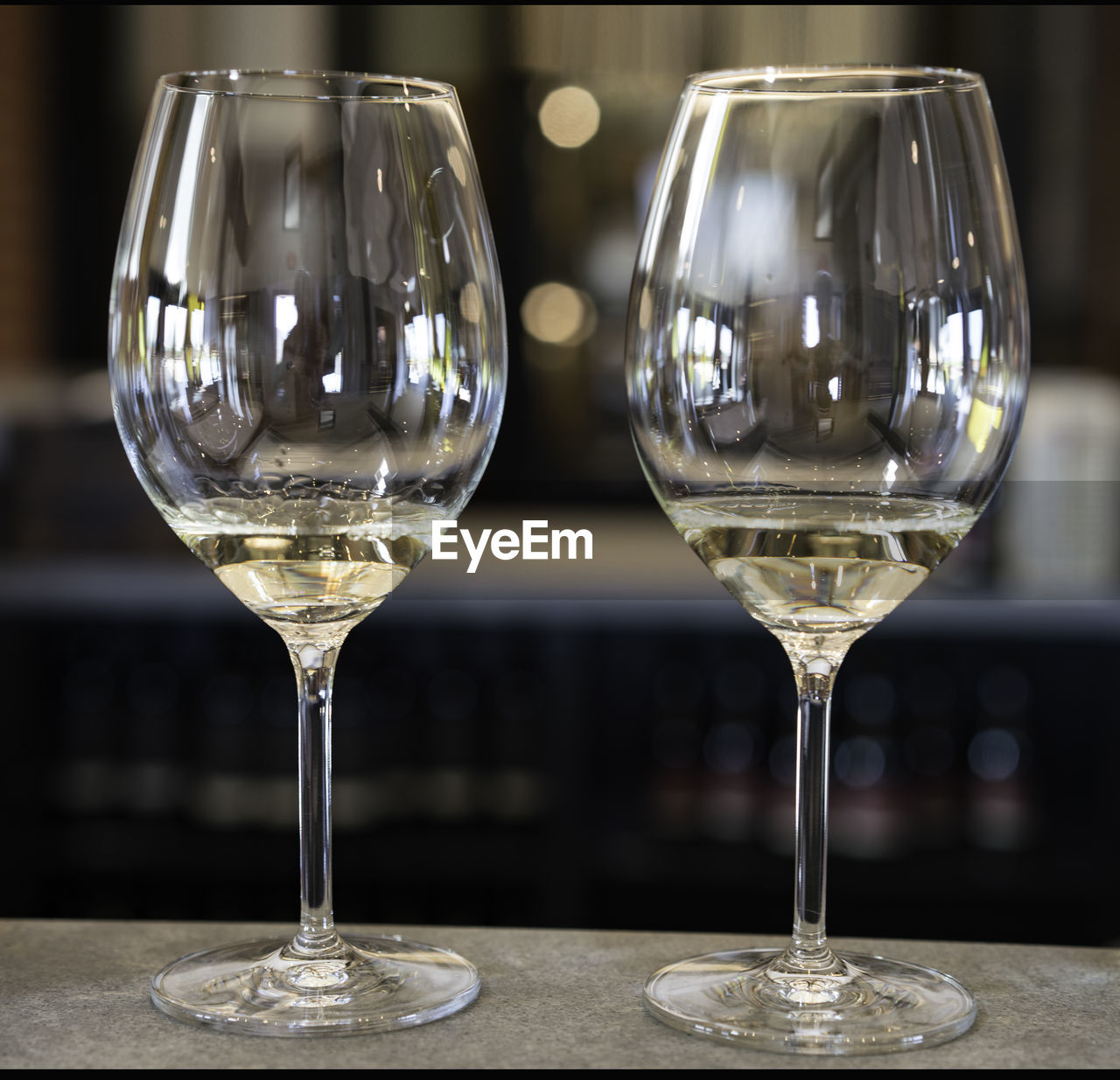 CLOSE-UP OF WINEGLASS IN GLASS ON TABLE