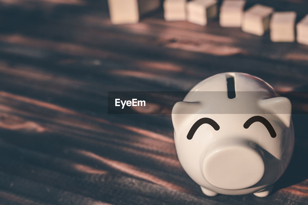 High angle view of piggy bank on wooden table