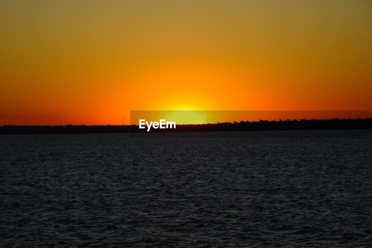 SCENIC VIEW OF SUNSET OVER SEA