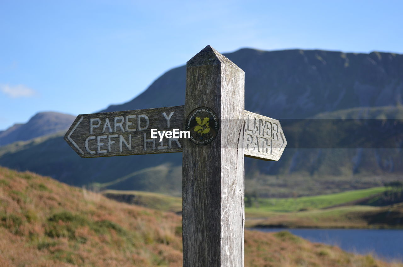 Low angle view of footpath sign post