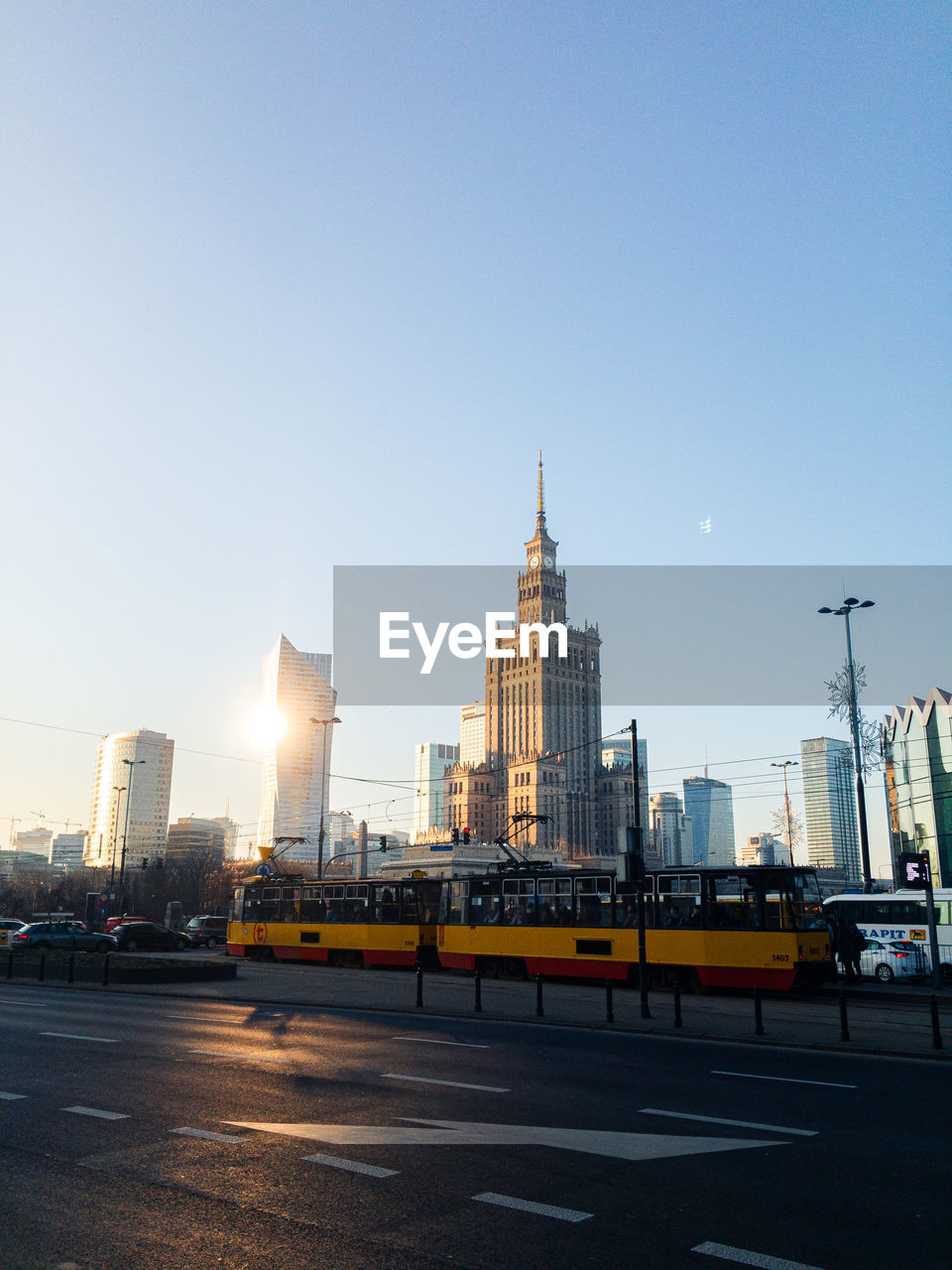 Buildings in city against clear blue sky