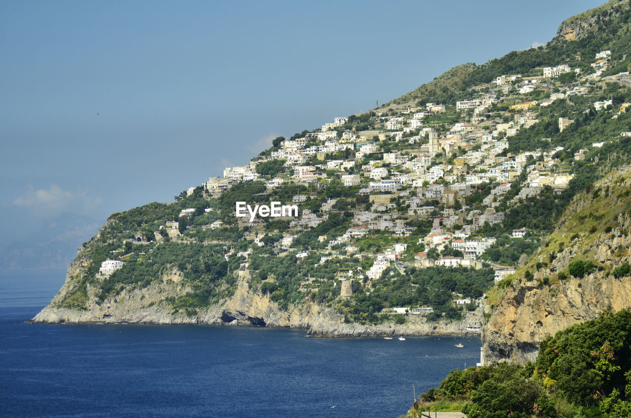 Scenic view of sea and mountains against sky