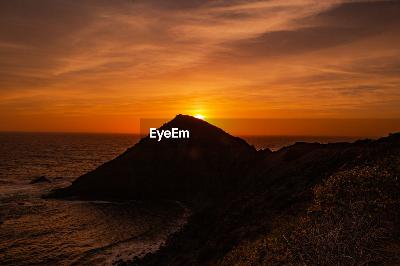 Scenic view of sea against romantic sky at sunset