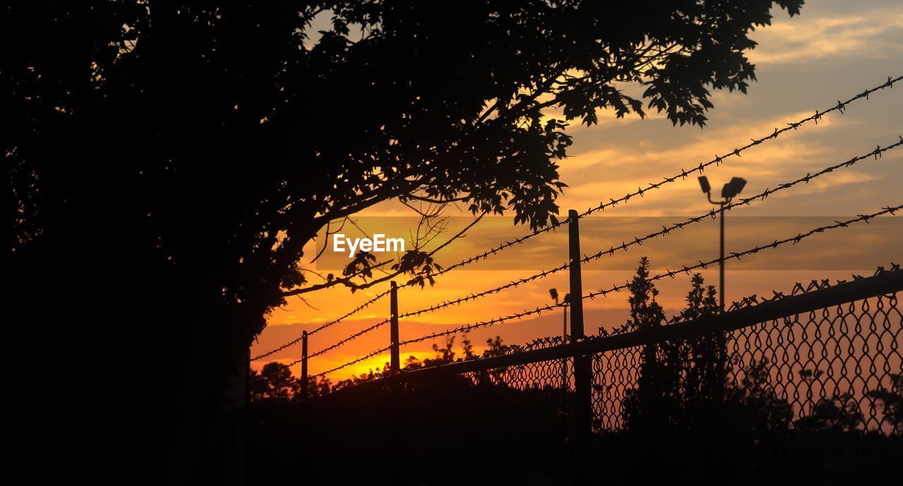 Low angle view of silhouette bridge against sky during sunset